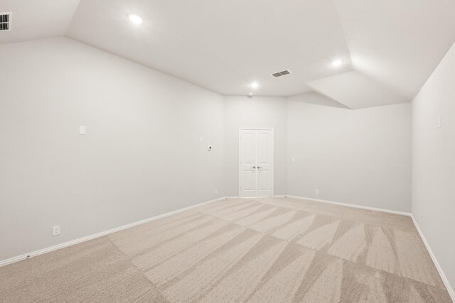 carpeted living room with vaulted ceiling