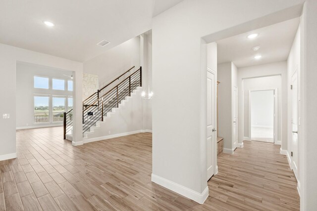 dining area with hardwood / wood-style floors, a notable chandelier, and a high ceiling