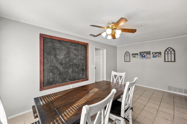 dining space featuring ceiling fan and light tile patterned floors