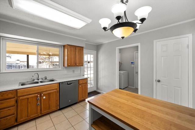 kitchen featuring sink, crown molding, light tile patterned floors, black dishwasher, and pendant lighting