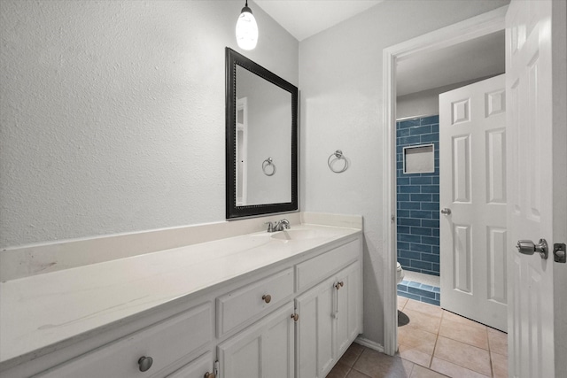 bathroom featuring vanity, tile patterned floors, and toilet