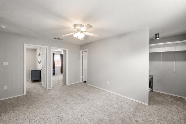 spare room featuring light colored carpet and ceiling fan