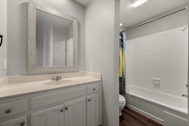 full bathroom with hardwood / wood-style flooring, vanity, toilet, and shower / tub combo