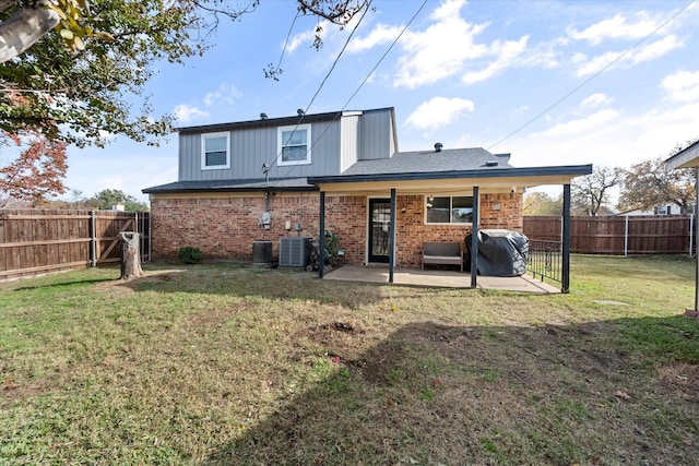 rear view of property with a patio area, central air condition unit, and a lawn