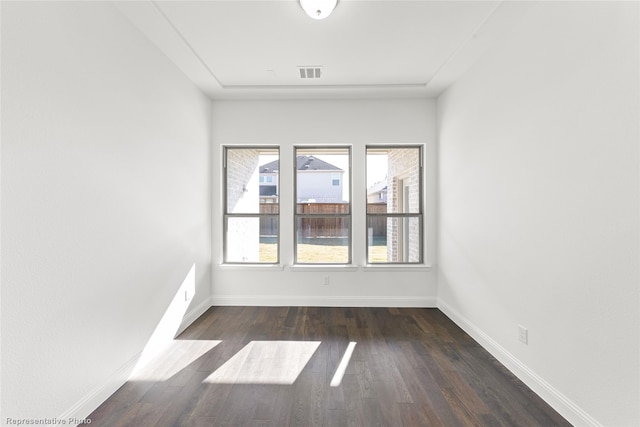 spare room with dark hardwood / wood-style flooring