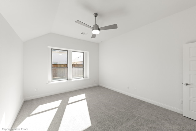 spare room with lofted ceiling, ceiling fan, and carpet flooring