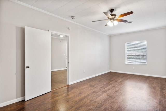 spare room with dark hardwood / wood-style floors, ceiling fan, and crown molding