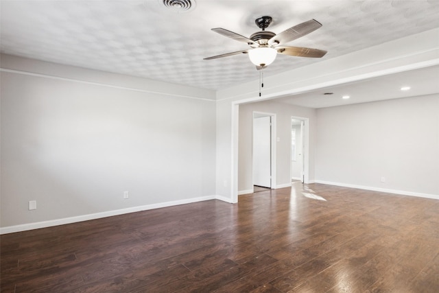 empty room with dark hardwood / wood-style floors and ceiling fan