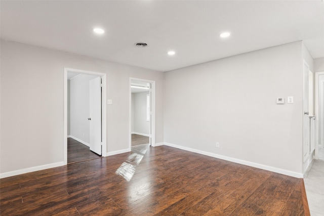 spare room featuring dark wood-type flooring