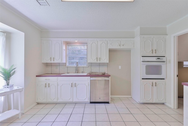 kitchen with white cabinets, dishwasher, sink, and white oven