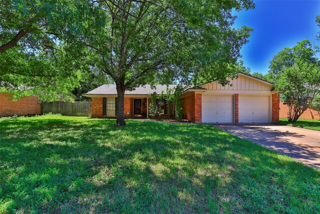 ranch-style house with a garage and a front yard