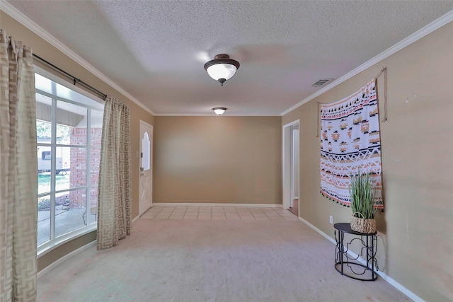 carpeted empty room featuring crown molding and a textured ceiling