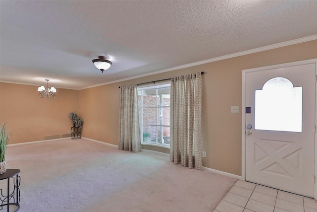 foyer entrance with a textured ceiling, a notable chandelier, crown molding, and light carpet