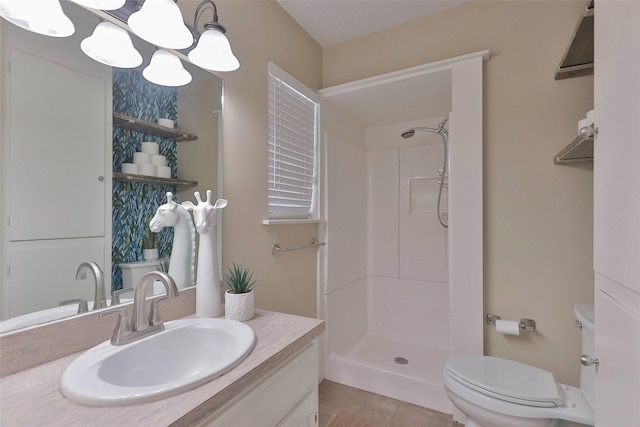 bathroom with an inviting chandelier, tile patterned flooring, a shower, toilet, and vanity