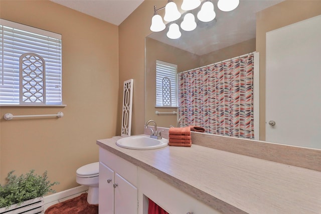 bathroom with vanity, toilet, and a baseboard heating unit