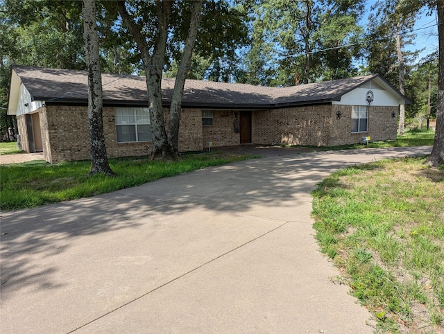 single story home with a front yard and a garage