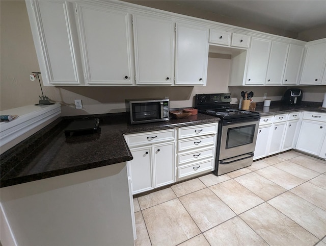 kitchen featuring white cabinets, light tile patterned floors, and appliances with stainless steel finishes