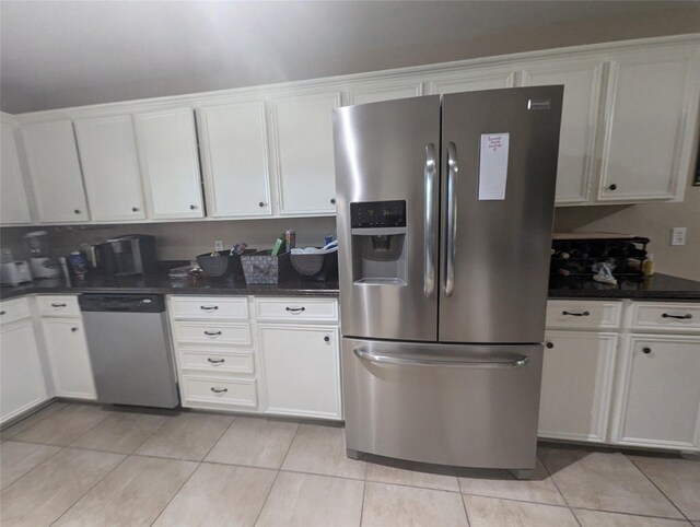 kitchen featuring white cabinets, light tile patterned floors, and appliances with stainless steel finishes