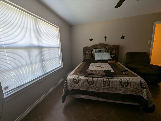 bedroom featuring dark tile patterned flooring and ceiling fan