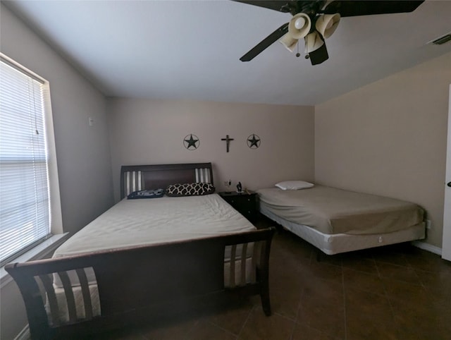 bedroom featuring dark tile patterned floors and ceiling fan