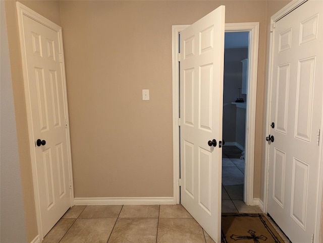 corridor featuring light tile patterned floors