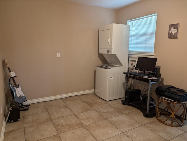 laundry room featuring light tile patterned floors and stacked washer / dryer