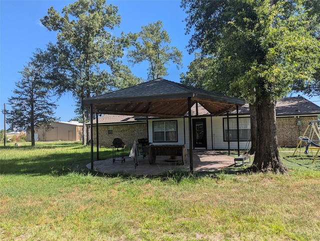 back of property featuring a lawn and a patio area