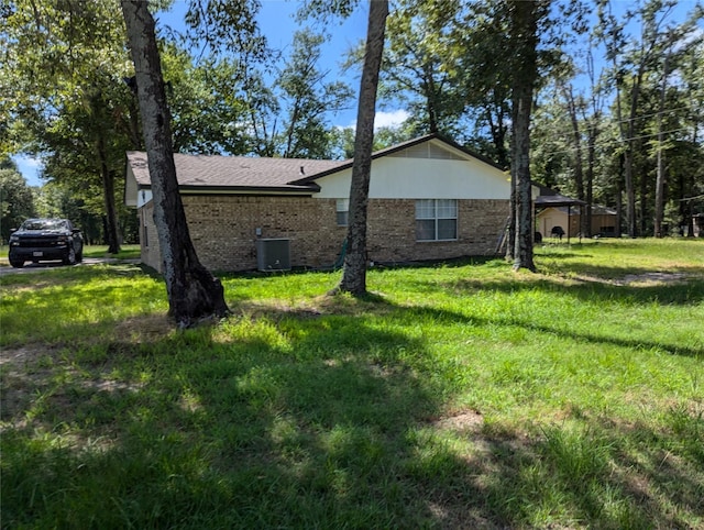 view of property exterior featuring central air condition unit and a yard