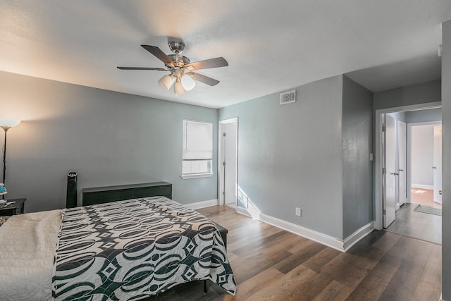 bedroom with ceiling fan and dark wood-type flooring