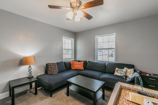 carpeted living room with ceiling fan