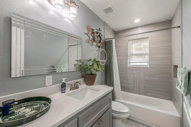 full bathroom featuring shower / bath combination with curtain, vanity, and toilet