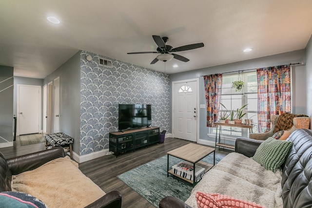 living room featuring ceiling fan and dark hardwood / wood-style flooring