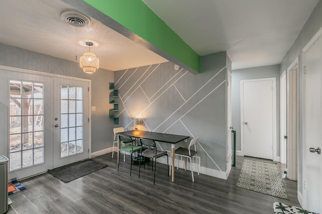 dining area featuring french doors, tile walls, dark wood-type flooring, and beam ceiling