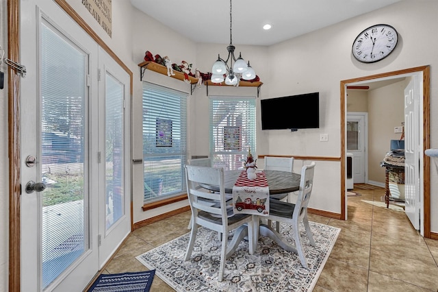 tiled dining space featuring a chandelier