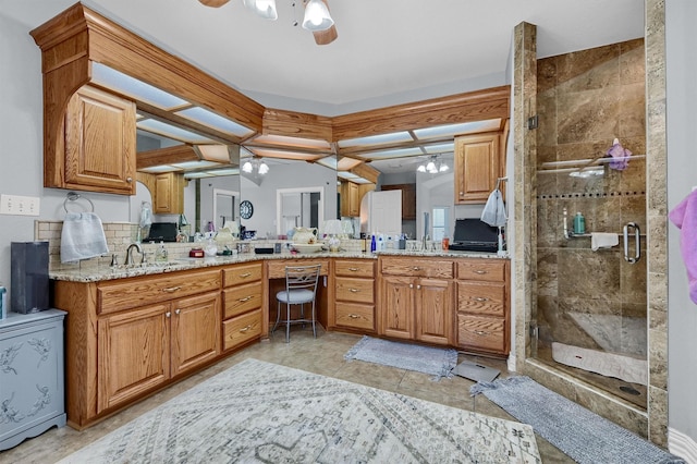 bathroom featuring tile patterned floors, vanity, ceiling fan, and a shower with door