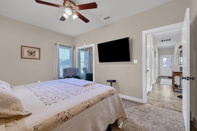 bedroom with ceiling fan, light carpet, and multiple windows