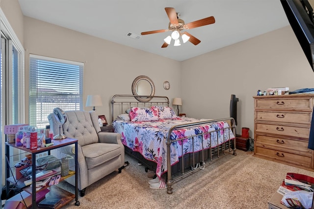 carpeted bedroom featuring a closet and ceiling fan