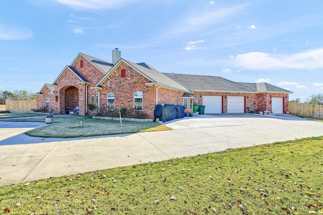 view of front of property featuring a garage and a front yard