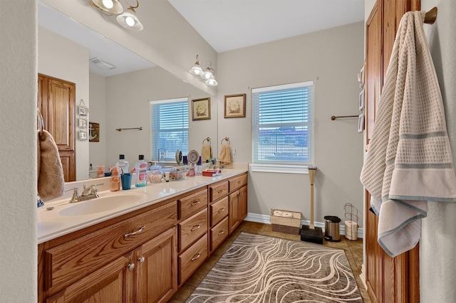 bathroom with vanity, tile patterned floors, and a healthy amount of sunlight