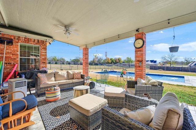 view of patio with a fenced in pool, ceiling fan, and an outdoor hangout area