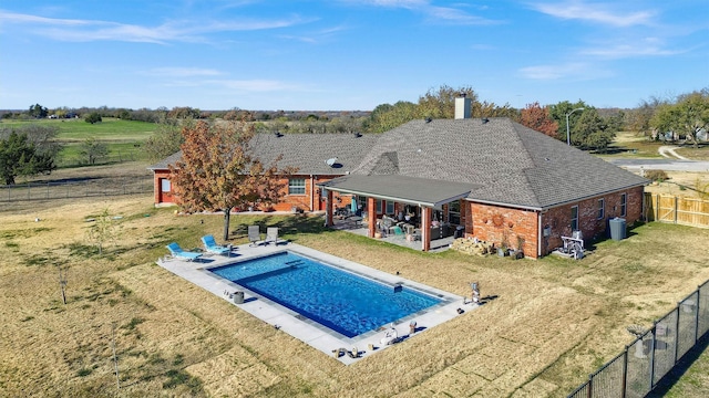 view of swimming pool with a patio area and a lawn