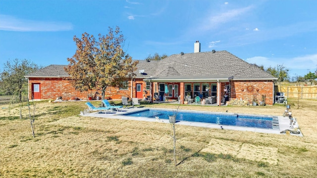 view of swimming pool featuring a patio and a lawn