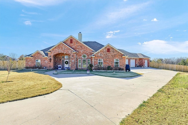 ranch-style home with a garage and a front lawn