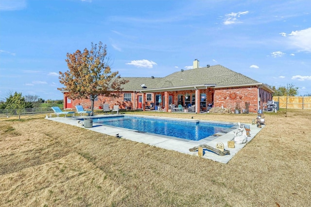 view of swimming pool featuring a lawn and a patio