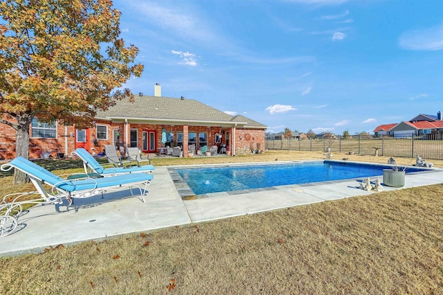 view of pool featuring a lawn and a patio