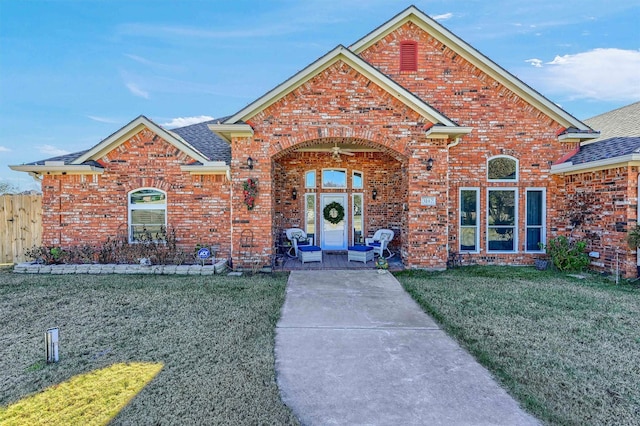 view of property featuring a front lawn