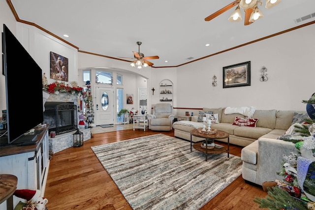 living room with ceiling fan, ornamental molding, and hardwood / wood-style flooring