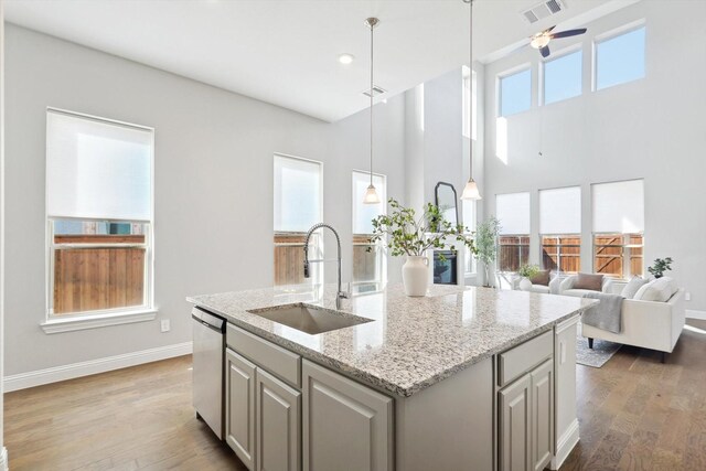 727 Waterbrook Pkwy, Argyle, TX 76226 - kitchen with visible vents, dishwasher, wood finished floors, a kitchen island with sink, and a sink