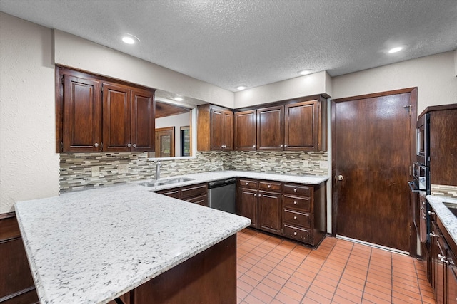 kitchen with appliances with stainless steel finishes, kitchen peninsula, sink, and dark brown cabinets