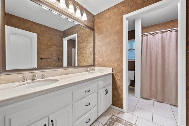 bathroom with vanity, tile patterned floors, and toilet